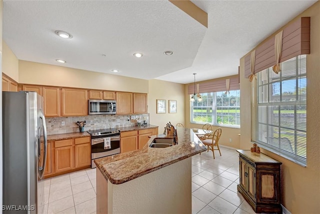 kitchen featuring stainless steel appliances, light tile patterned flooring, a sink, and tasteful backsplash