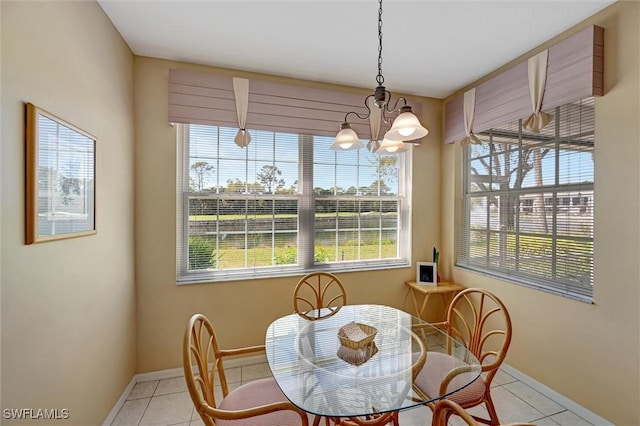 dining space with plenty of natural light, baseboards, a notable chandelier, and light tile patterned flooring