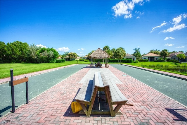 view of property's community with a gazebo and a yard