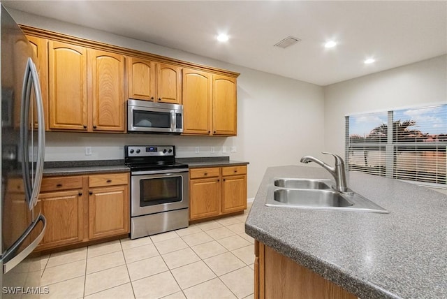 kitchen with light tile patterned floors, recessed lighting, stainless steel appliances, a sink, and visible vents