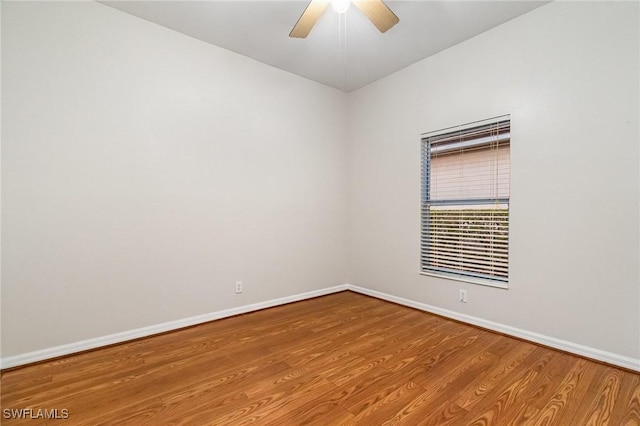 unfurnished room featuring wood finished floors, a ceiling fan, and baseboards