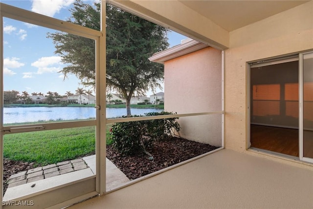 sunroom / solarium with a water view