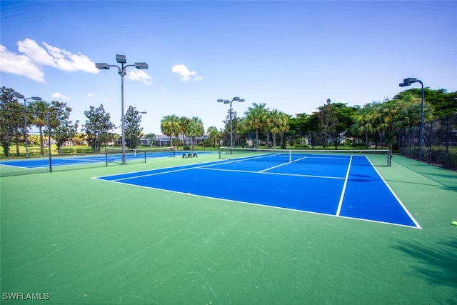 view of sport court featuring fence