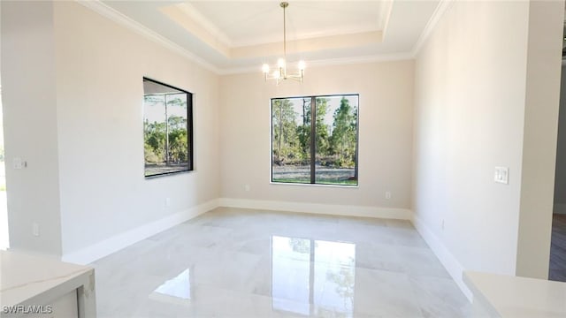 empty room with ornamental molding, a raised ceiling, and plenty of natural light