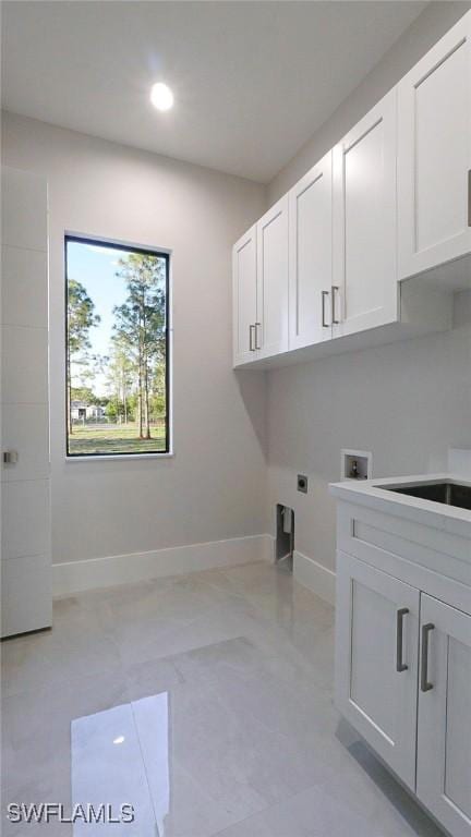 laundry room with cabinet space, baseboards, hookup for a washing machine, electric dryer hookup, and recessed lighting