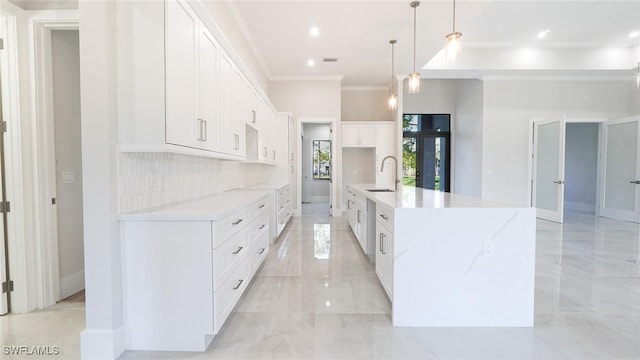 kitchen featuring a sink, white cabinets, marble finish floor, decorative backsplash, and crown molding