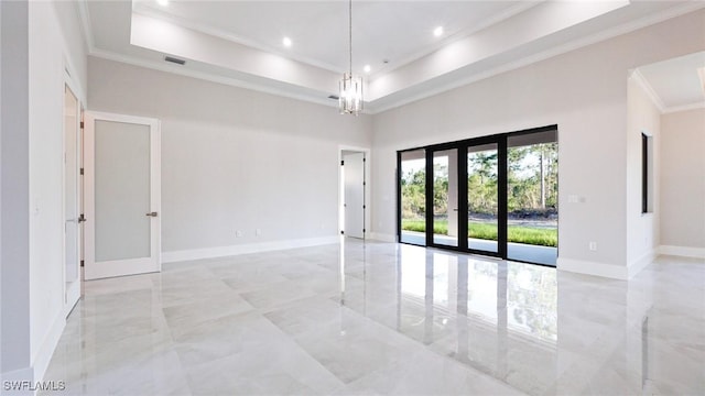 spare room with baseboards, french doors, a raised ceiling, and crown molding