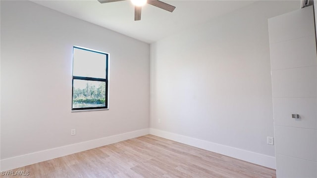 empty room featuring light wood-style floors, ceiling fan, and baseboards