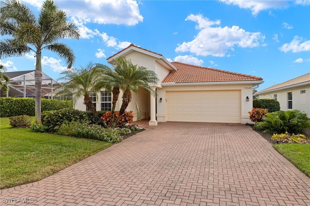 9325 La Bianco St, Estero, FL 33967 - mediterranean / spanish-style house with an attached garage, a tiled roof, decorative driveway, and stucco siding