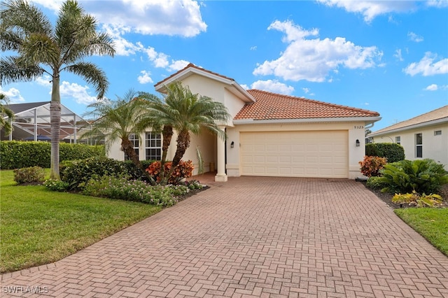 mediterranean / spanish-style house with an attached garage, a tiled roof, decorative driveway, and stucco siding