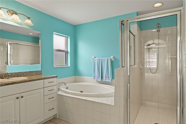 9325 La Bianco St, Estero, FL 33967 - full bathroom featuring a whirlpool tub, a stall shower, tile patterned floors, and vanity