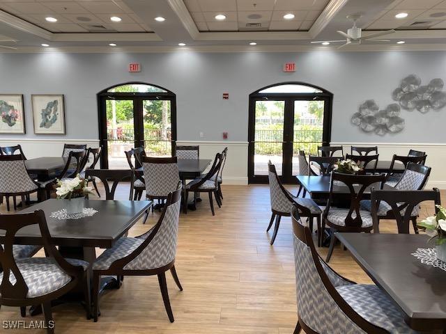9325 La Bianco St, Estero, FL 33967 - dining area with a tray ceiling, a wealth of natural light, and french doors