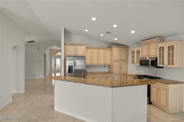9325 La Bianco St, Estero, FL 33967 - kitchen featuring arched walkways, visible vents, vaulted ceiling, appliances with stainless steel finishes, and a center island with sink