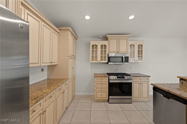 9325 La Bianco St, Estero, FL 33967 - kitchen with appliances with stainless steel finishes, glass insert cabinets, cream cabinetry, and recessed lighting