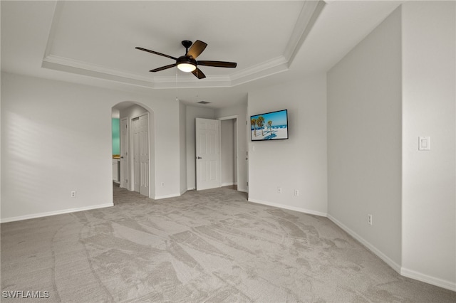 9325 La Bianco St, Estero, FL 33967 - carpeted empty room with arched walkways, a ceiling fan, baseboards, ornamental molding, and a tray ceiling
