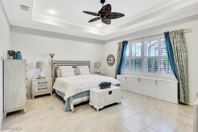 bedroom with a ceiling fan, visible vents, a tray ceiling, and ornamental molding