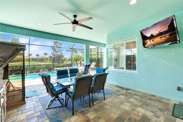 sunroom featuring ceiling fan