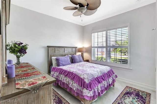 bedroom featuring baseboards, ornamental molding, and a ceiling fan