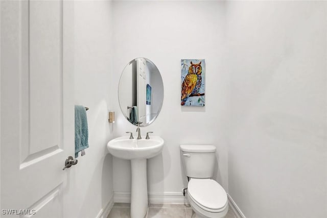 14821 Windward Ln, Naples, FL 34114 - bathroom with baseboards, tile patterned floors, and toilet