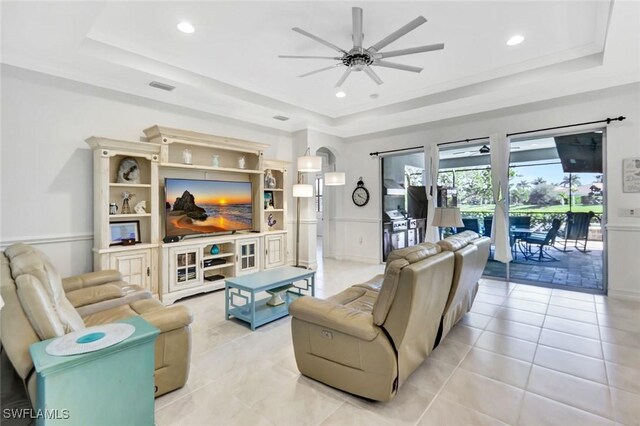 14821 Windward Ln, Naples, FL 34114 - living area with light tile patterned floors, a raised ceiling, ceiling fan, and visible vents
