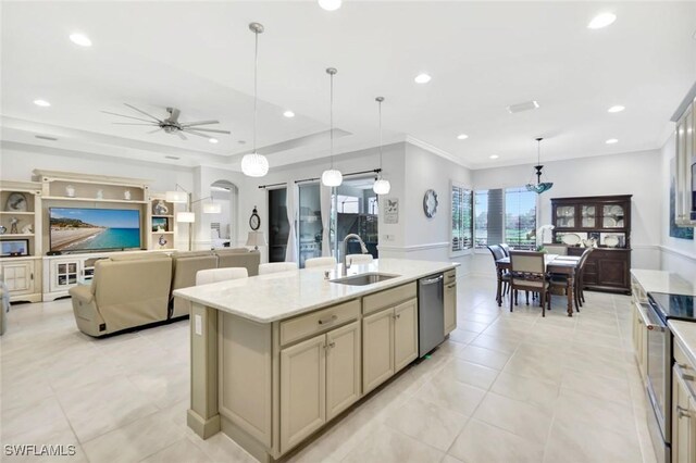 14821 Windward Ln, Naples, FL 34114 - kitchen with ceiling fan, a center island with sink, a sink, light tile patterned floors, and stainless steel appliances
