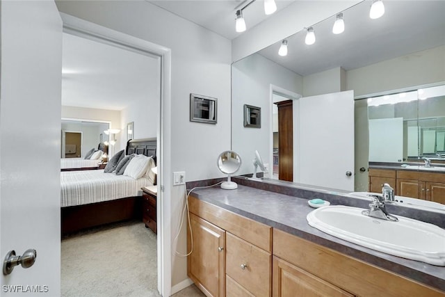 ensuite bathroom featuring connected bathroom and vanity