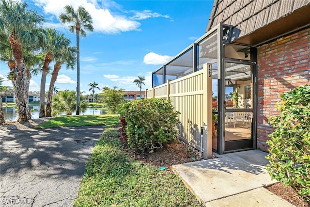 exterior space featuring a water view and brick siding