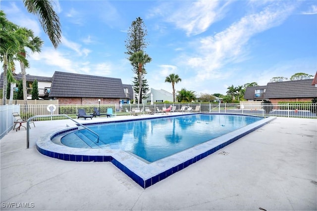 community pool featuring fence and a patio