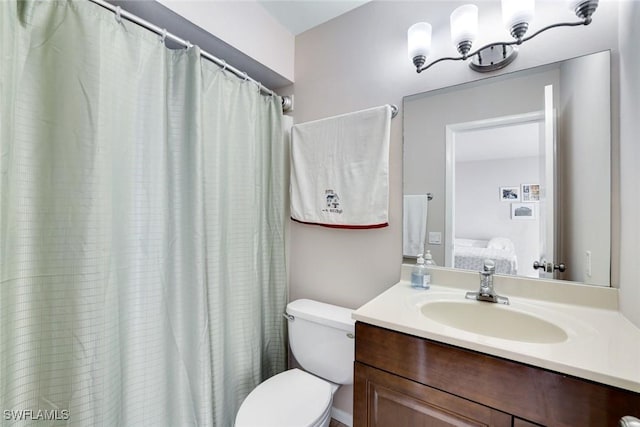 ensuite bathroom with toilet, ensuite bath, and vanity