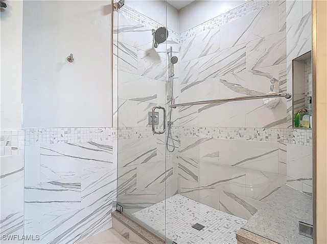 full bathroom with tile walls and a stall shower