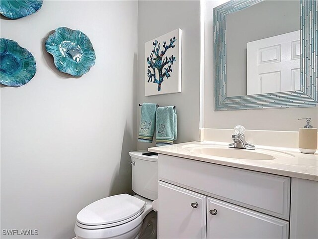 bathroom featuring toilet and vanity