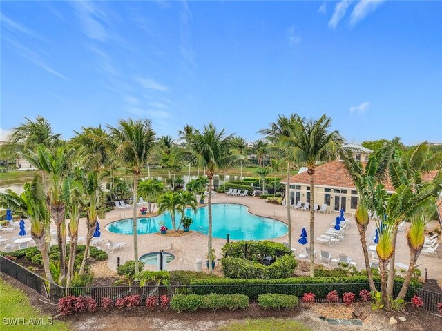 pool featuring fence and a patio area