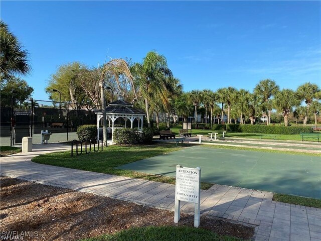 view of community featuring a gazebo, a yard, and fence