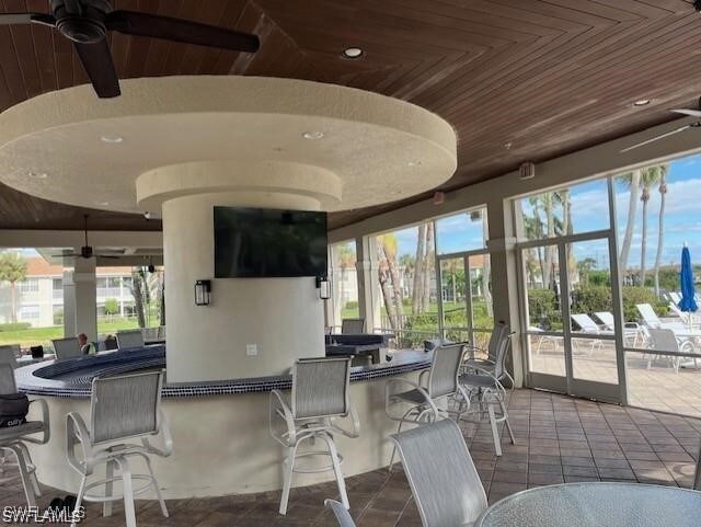 exterior space featuring wood ceiling and a ceiling fan