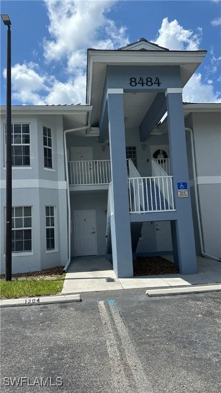 8484 Bernwood Cove Loop Unit 1301, Fort Myers, FL 33966 - view of property featuring uncovered parking