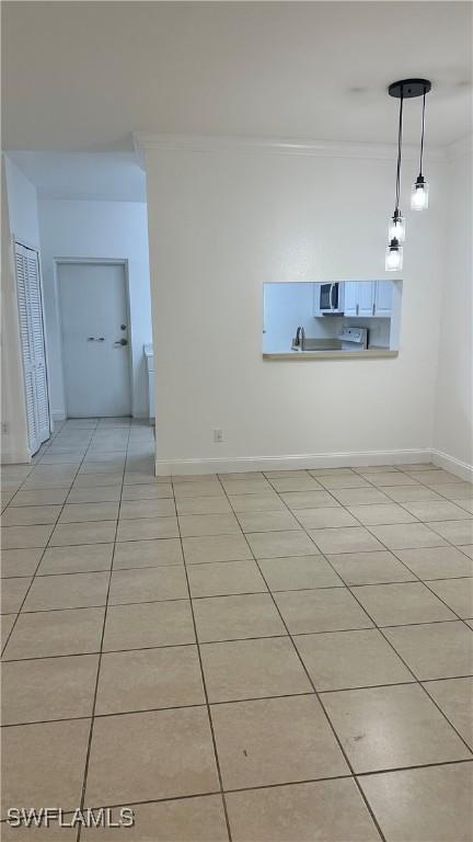 8484 Bernwood Cove Loop Unit 1301, Fort Myers, FL 33966 - unfurnished room with ornamental molding, light tile patterned flooring, and baseboards