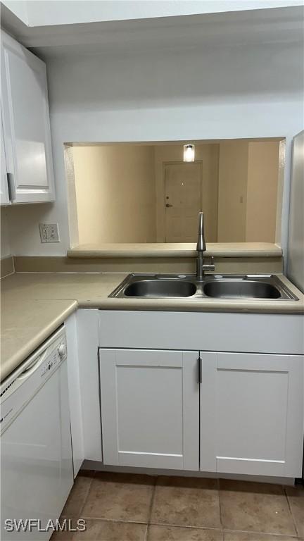 8484 Bernwood Cove Loop Unit 1301, Fort Myers, FL 33966 - kitchen featuring dishwasher, a sink, white cabinets, light countertops, and tile patterned flooring