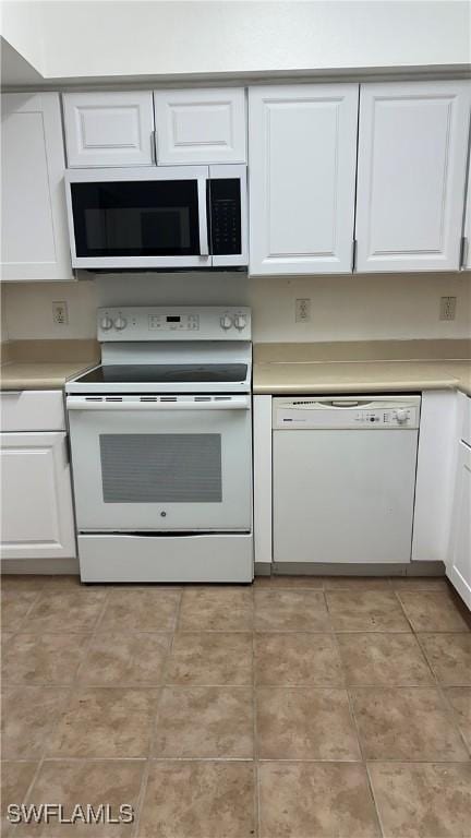 8484 Bernwood Cove Loop Unit 1301, Fort Myers, FL 33966 - kitchen featuring white appliances, white cabinets, and light countertops