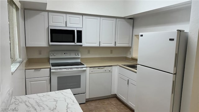 8484 Bernwood Cove Loop Unit 1301, Fort Myers, FL 33966 - kitchen featuring white appliances, light countertops, and white cabinets
