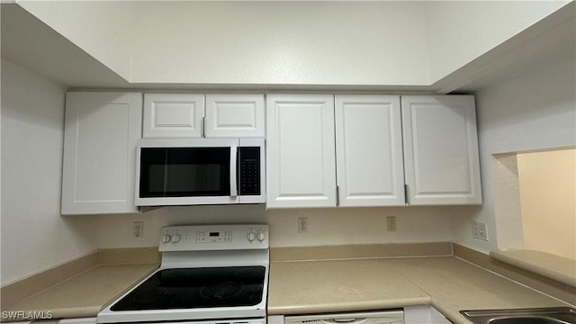 8484 Bernwood Cove Loop Unit 1301, Fort Myers, FL 33966 - kitchen featuring appliances with stainless steel finishes, white cabinets, and light countertops