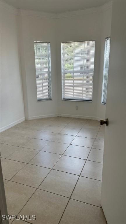8484 Bernwood Cove Loop Unit 1301, Fort Myers, FL 33966 - empty room with light tile patterned floors, crown molding, and baseboards