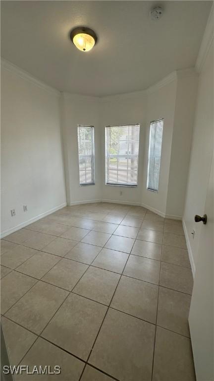 8484 Bernwood Cove Loop Unit 1301, Fort Myers, FL 33966 - unfurnished room with light tile patterned flooring, ornamental molding, baseboards, and a smoke detector