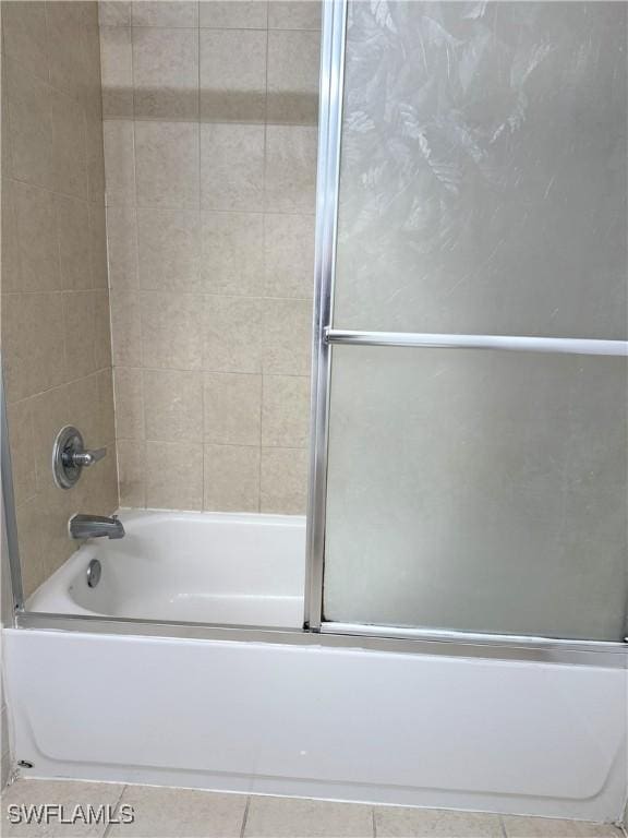 8484 Bernwood Cove Loop Unit 1301, Fort Myers, FL 33966 - bathroom featuring tile patterned flooring and combined bath / shower with glass door