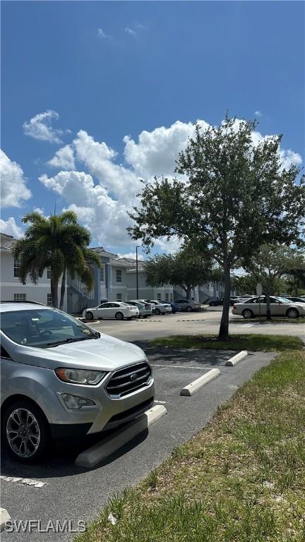 8484 Bernwood Cove Loop Unit 1301, Fort Myers, FL 33966 - uncovered parking lot with a residential view