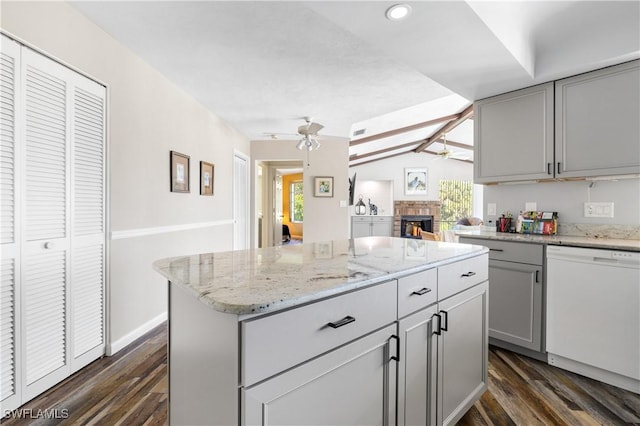 kitchen with lofted ceiling with beams, ceiling fan, white dishwasher, gray cabinets, and a fireplace