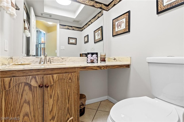 bathroom with tile patterned flooring, toilet, visible vents, baseboards, and a raised ceiling