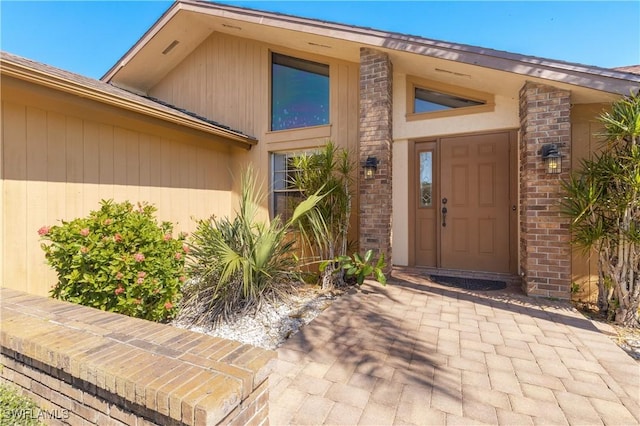 doorway to property with brick siding