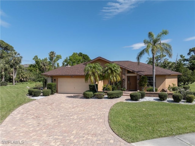 view of front facade featuring an attached garage, decorative driveway, and a front yard