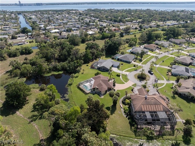 birds eye view of property featuring a water view and a residential view