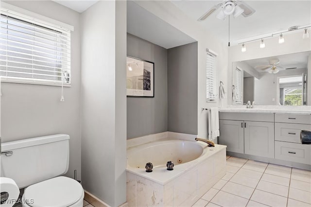 full bath featuring ceiling fan, tile patterned flooring, toilet, vanity, and a jetted tub